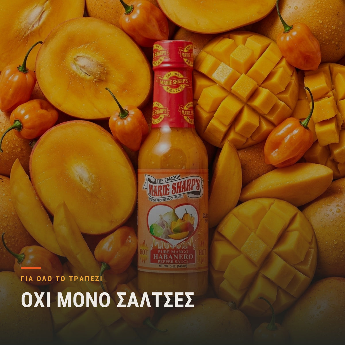 Μπουκάλι σάλτσας μάνγκο και habanero ανάμεσα σε φρέσκα μάνγκο, dips salsas και chutney